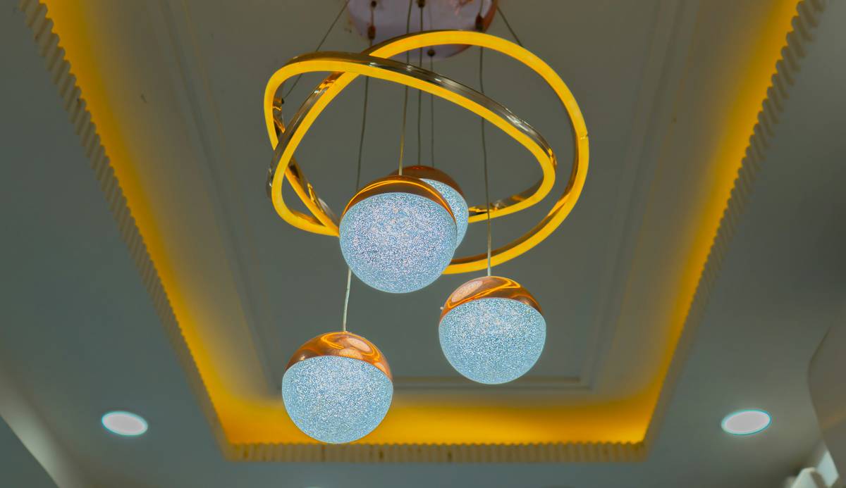 Close-up of led lights in recessed lighting fixtures installed in a white ceiling with warm glow