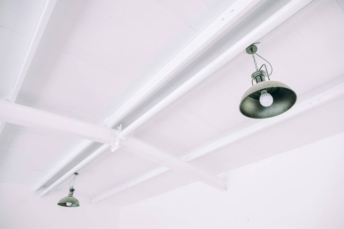 Recessed lighting for new construction showing evenly spaced fixtures in an unfinished ceiling with labeled measurements